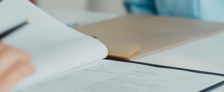 Close up of paperwork and a Manilla folder