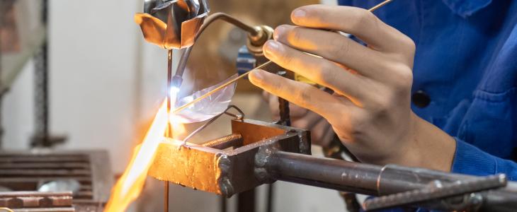 Worker welding steel without gloves