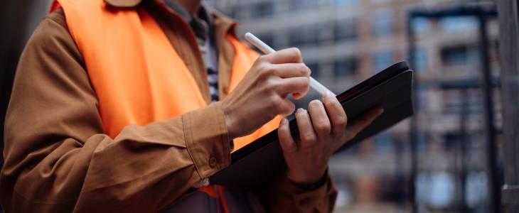 Woman worker writing on a tablet