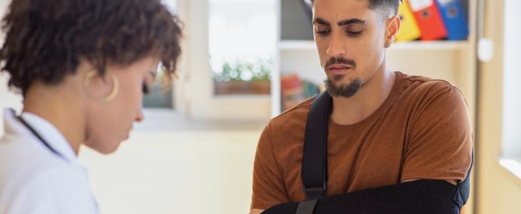 Injured warehouse worker managing bills