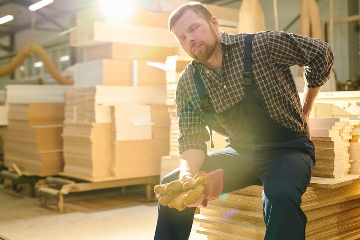 Tired handsome bearded manual worker